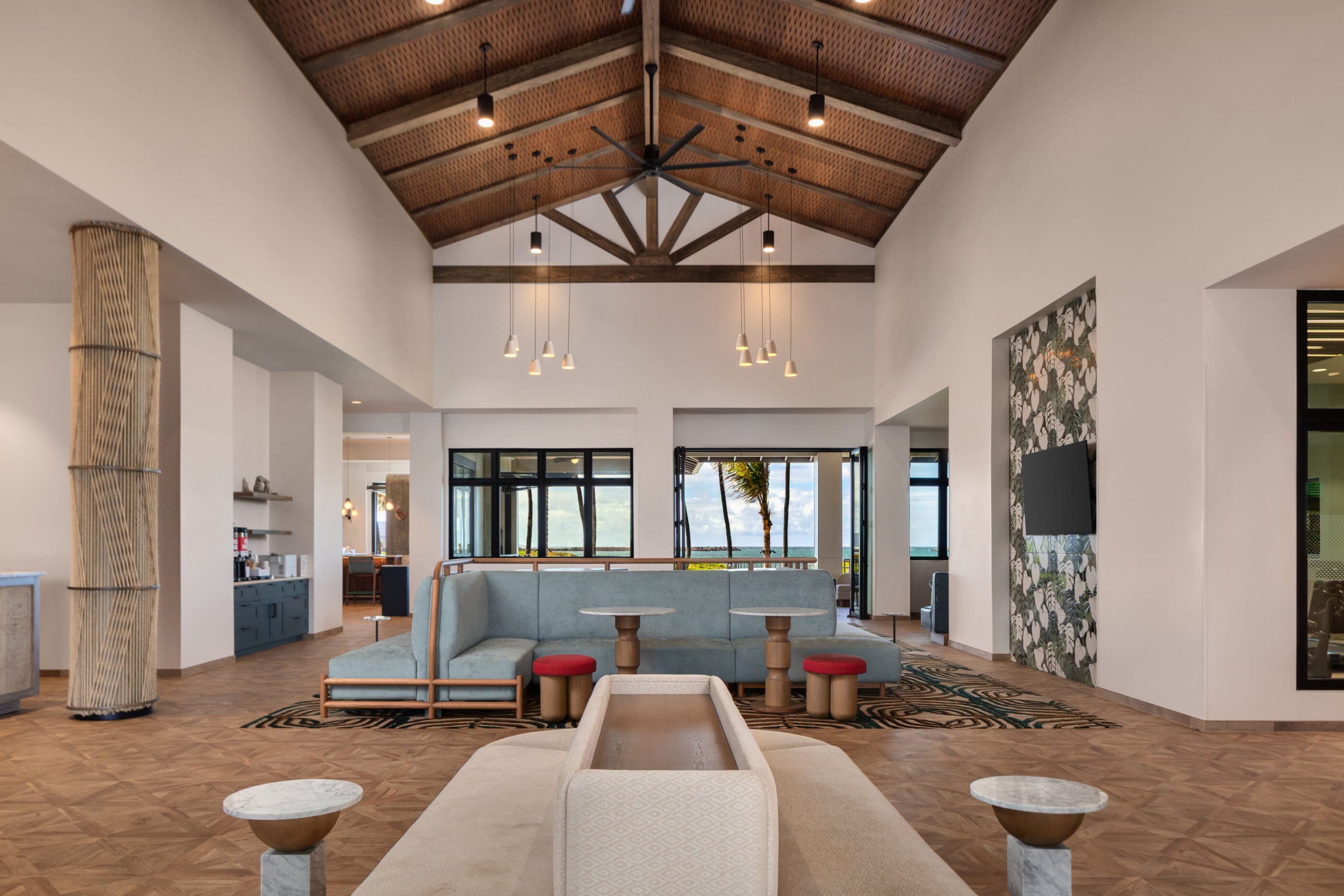Hotel lobby lounge with vaulted wood ceiling and blue seating