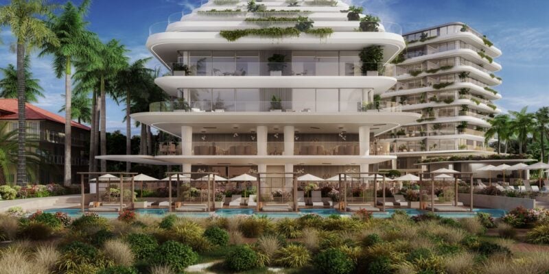 White modern resort building among palms