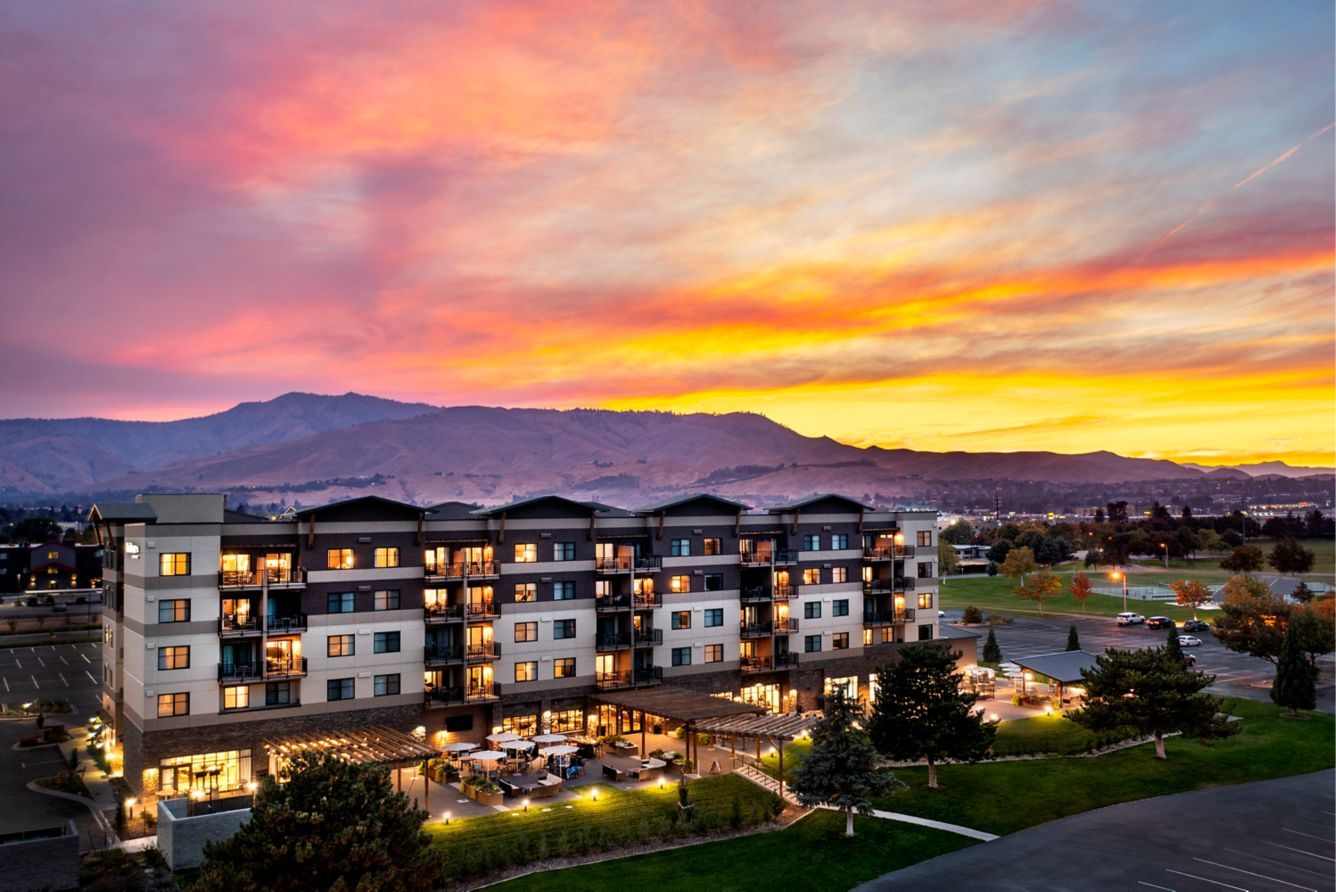 Hotel exterior under a colourful sunset sky