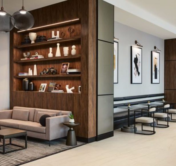 Hotel lobby lounge with timber shelving and framed art